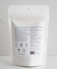 A white bag with a white label on it containing Turkey Tail Mushroom Powder 2 oz. | 50 servings by Faire.com.